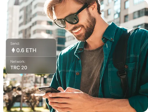 An investor holding a smartphone, with a 0.6 ETH transfer on the TRC 20 network